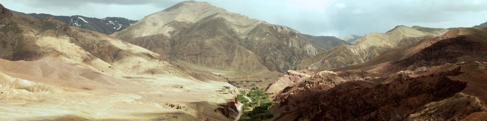 A mountain landscape, with a verdant Kabul to Bamyan road running through it.